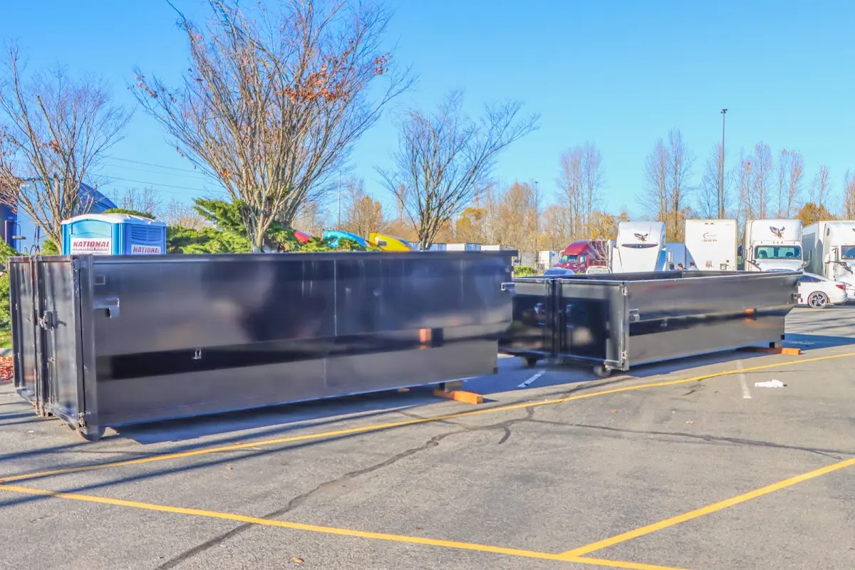 Professional dumpster rental service with roll-off container on residential driveway in Wahpeton